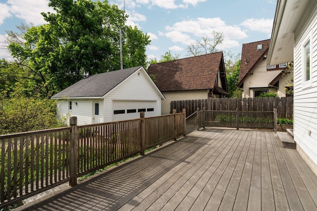 1054 Ferdon Rd, Ann Arbor, MI 48104 - wooden deck featuring a garage, an outbuilding, and fence
