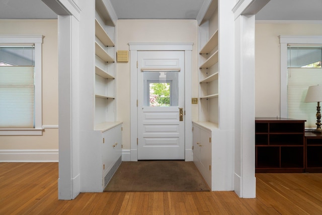 1054 Ferdon Rd, Ann Arbor, MI 48104 - doorway to outside with wood finished floors, plenty of natural light, crown molding, and baseboards