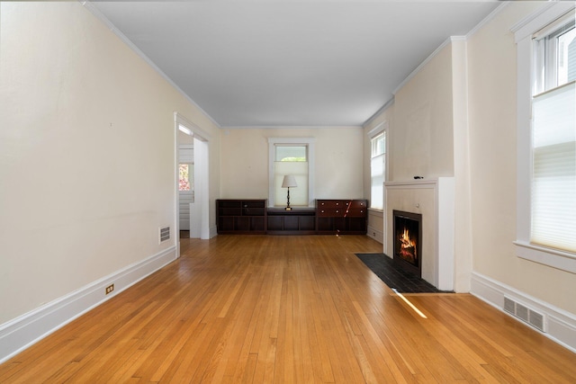 1054 Ferdon Rd, Ann Arbor, MI 48104 - unfurnished living room with a fireplace with flush hearth, light wood-style flooring, baseboards, and ornamental molding