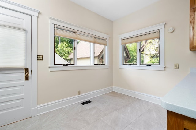 1054 Ferdon Rd, Ann Arbor, MI 48104 - unfurnished dining area featuring plenty of natural light and baseboards