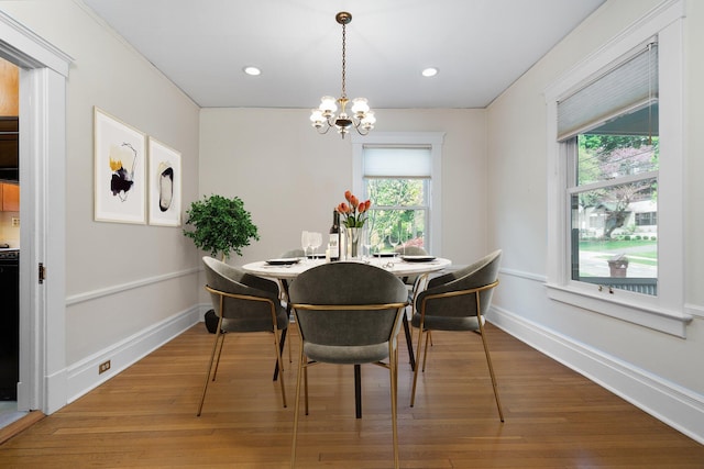 1054 Ferdon Rd, Ann Arbor, MI 48104 - dining space with healthy amount of natural light, a chandelier, wood finished floors, baseboards, and recessed lighting
