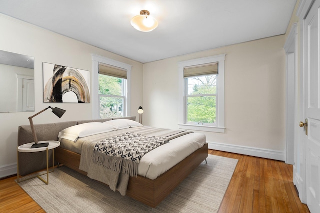 1054 Ferdon Rd, Ann Arbor, MI 48104 - bedroom featuring wood-type flooring and baseboards