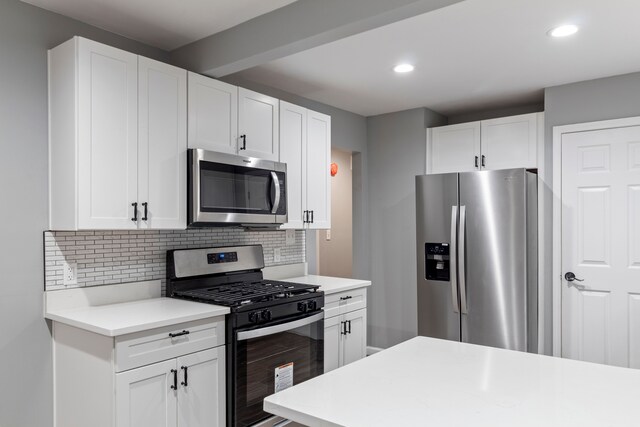 20172 Stotter St, Detroit, MI 48234 - kitchen with appliances with stainless steel finishes, light countertops, tasteful backsplash, white cabinetry, and recessed lighting