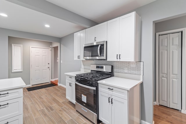 20172 Stotter St, Detroit, MI 48234 - kitchen featuring stainless steel appliances, baseboards, light countertops, recessed lighting, and tasteful backsplash