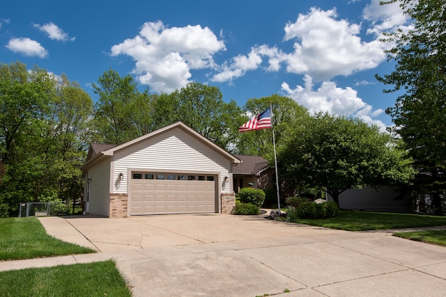 906 Village Dr, Davison, MI 48423 - view of front facade featuring brick siding, an attached garage, driveway, and a front lawn