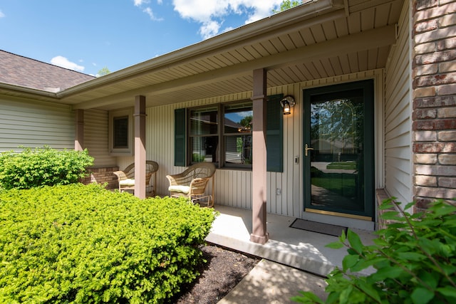 906 Village Dr, Davison, MI 48423 - property entrance featuring a porch, brick siding, and roof with shingles