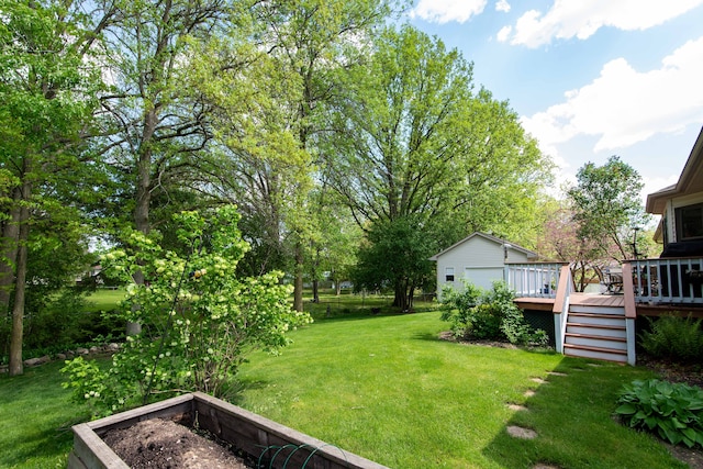 906 Village Dr, Davison, MI 48423 - view of grassy yard featuring a deck and a vegetable garden