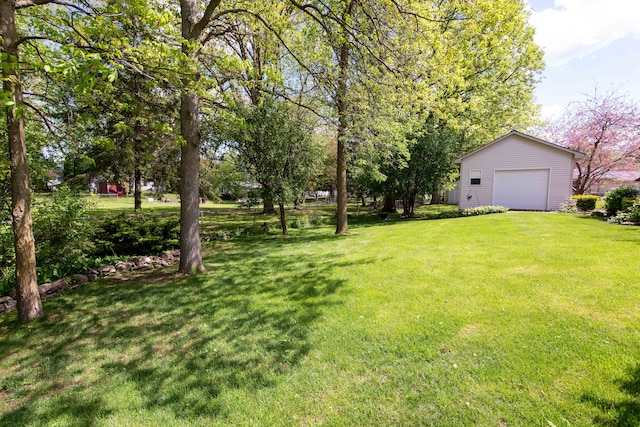 906 Village Dr, Davison, MI 48423 - view of grassy yard with an outdoor structure and a detached garage