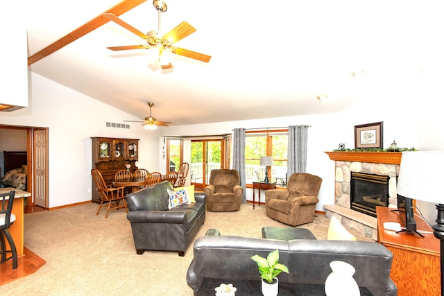 906 Village Dr, Davison, MI 48423 - living room featuring ceiling fan, a fireplace, baseboards, carpet, and high vaulted ceiling