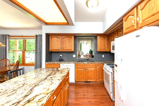 906 Village Dr, Davison, MI 48423 - kitchen featuring white appliances, a sink, healthy amount of natural light, and light stone counters