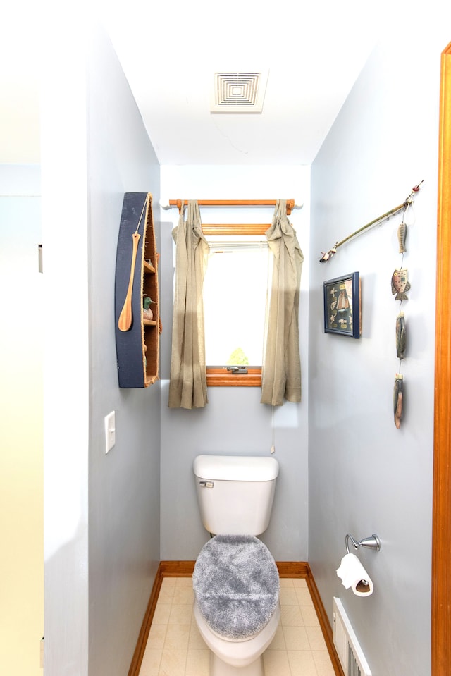 906 Village Dr, Davison, MI 48423 - bathroom with baseboards, toilet, and tile patterned floors