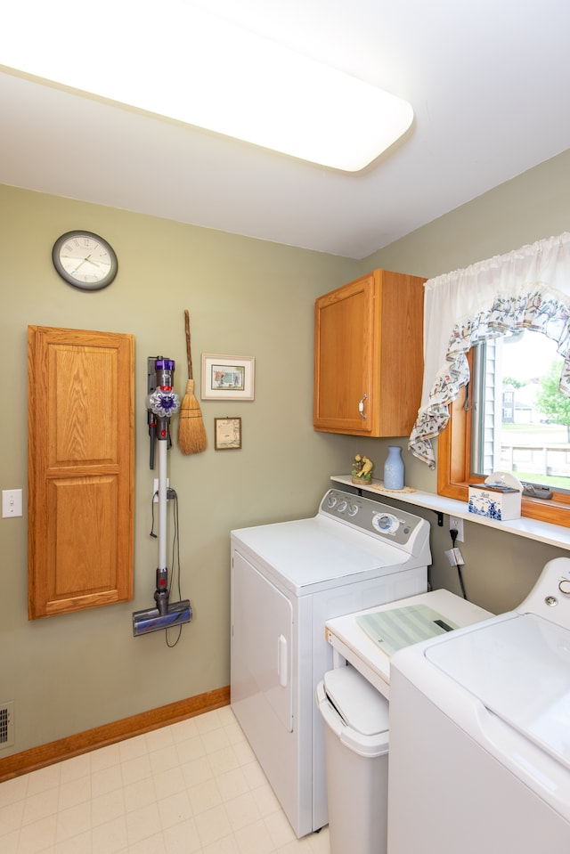 906 Village Dr, Davison, MI 48423 - washroom with cabinet space, washing machine and clothes dryer, baseboards, and light floors