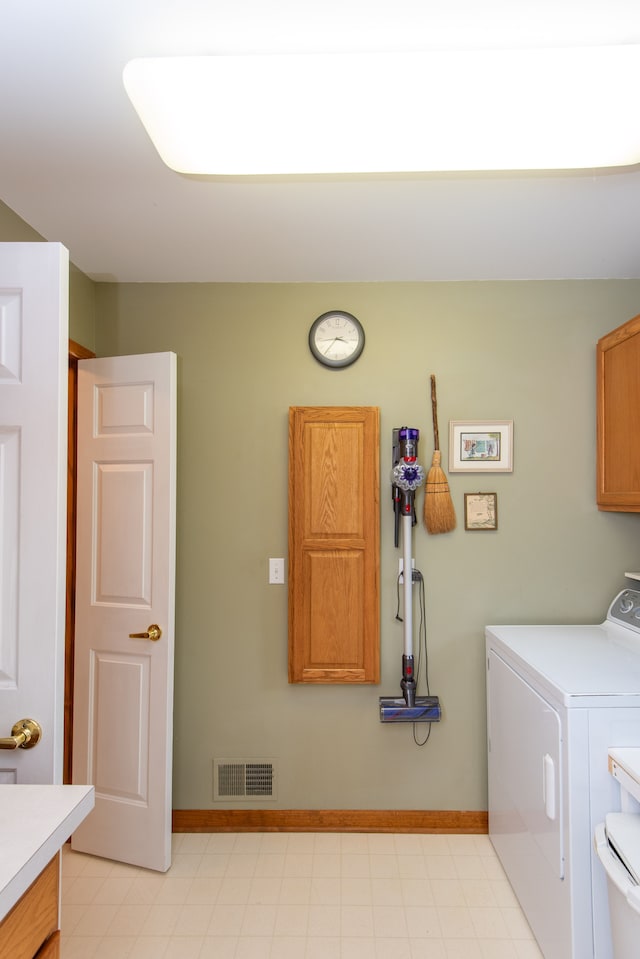 906 Village Dr, Davison, MI 48423 - laundry area featuring washer / clothes dryer, cabinet space, and baseboards