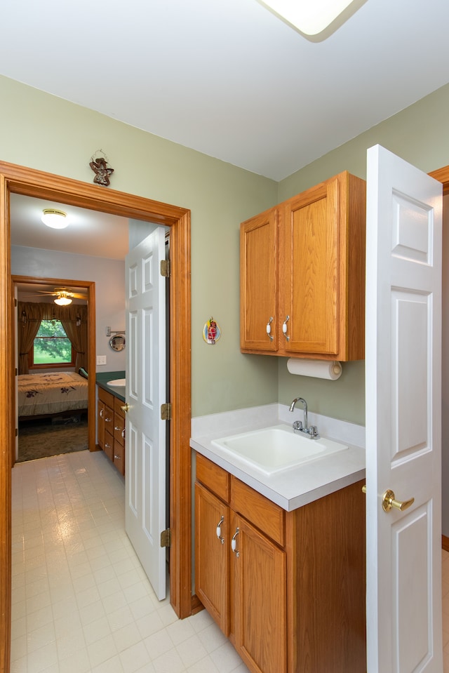 906 Village Dr, Davison, MI 48423 - kitchen with a sink, light countertops, and brown cabinets