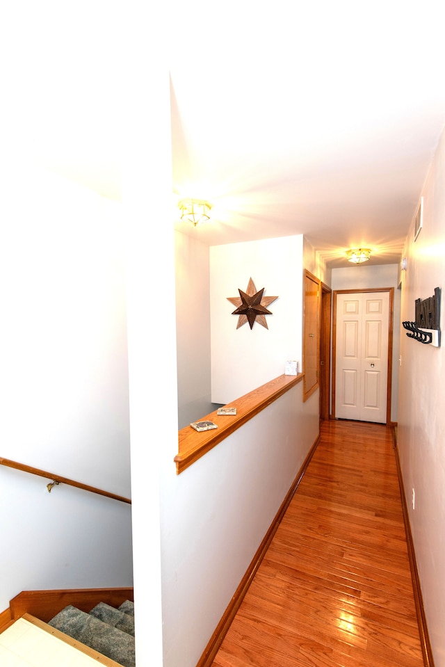 906 Village Dr, Davison, MI 48423 - corridor with light wood-style floors, baseboards, and stairs