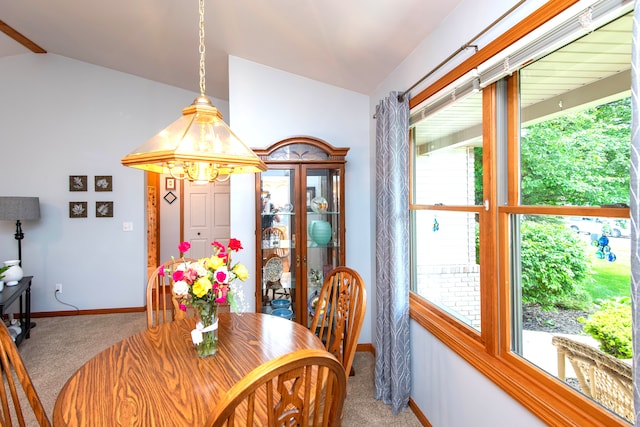 906 Village Dr, Davison, MI 48423 - carpeted dining area with vaulted ceiling, baseboards, and a chandelier