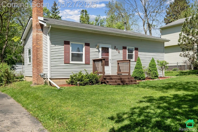 243 Reno St, Lake Orion, MI 48362 - view of front of home with a chimney and a front yard
