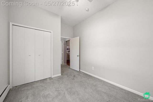 243 Reno St, Lake Orion, MI 48362 - unfurnished bedroom with baseboard heating, carpet, baseboards, a closet, and vaulted ceiling