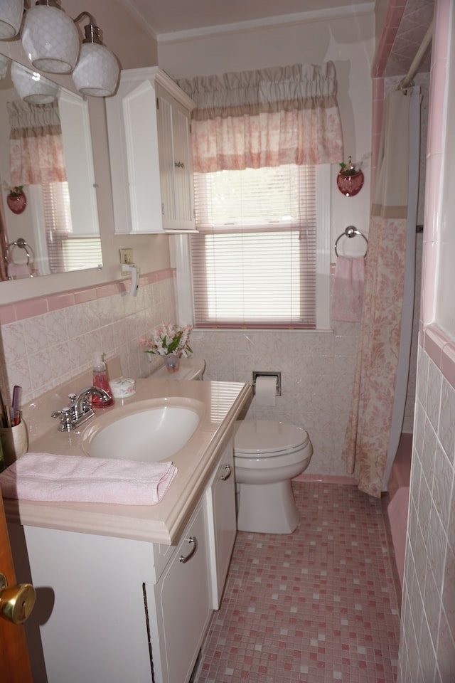 20727 Carlysle St, Dearborn, MI 48124 - bathroom with toilet, vanity, a shower with curtain, tile walls, and a wainscoted wall
