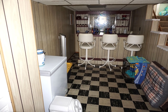 20727 Carlysle St, Dearborn, MI 48124 - indoor dry bar with tile patterned floors, wood walls, and a drop ceiling