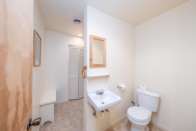 11290 Alpine Rd, Canadian Lakes, MI 49346 - bathroom with a sink, toilet, and baseboards