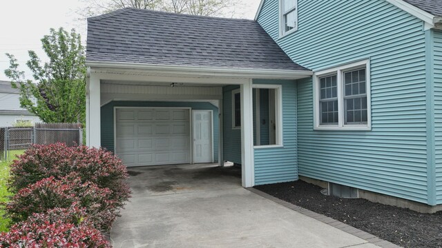 6 Congress Ct Unit D, Saginaw, MI 48602 - entrance to property with roof with shingles, concrete driveway, and a garage