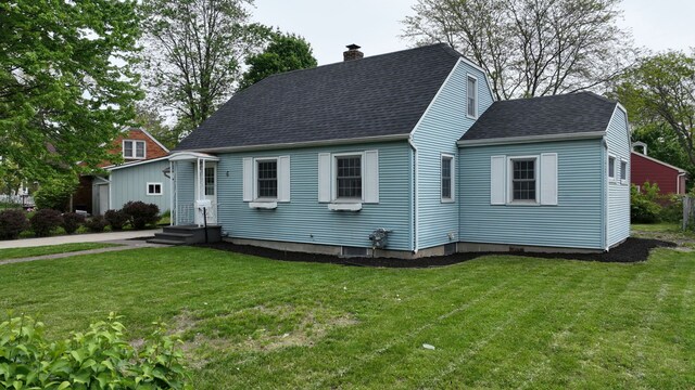 6 Congress Ct Unit D, Saginaw, MI 48602 - cape cod home featuring a chimney, a shingled roof, and a front lawn