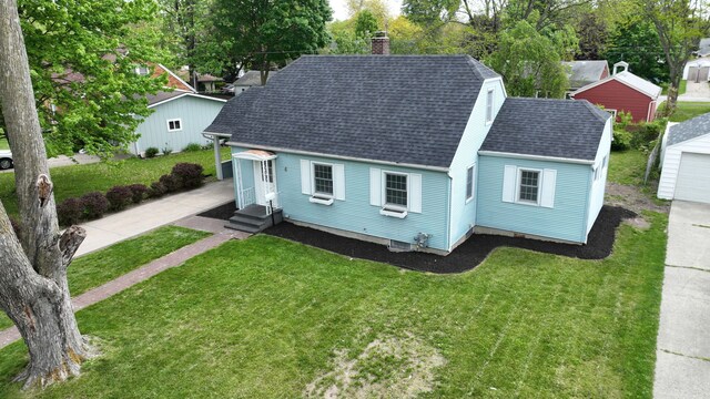 6 Congress Ct Unit D, Saginaw, MI 48602 - view of front of home featuring a shingled roof, a chimney, a front lawn, and entry steps