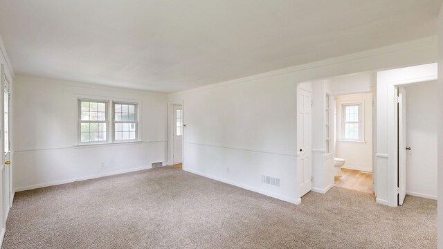 6 Congress Ct Unit D, Saginaw, MI 48602 - empty room featuring carpet, healthy amount of natural light, crown molding, and baseboards