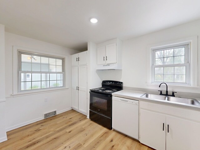 6 Congress Ct Unit D, Saginaw, MI 48602 - kitchen featuring white dishwasher, black range with electric stovetop, a sink, light wood-style flooring, and healthy amount of natural light
