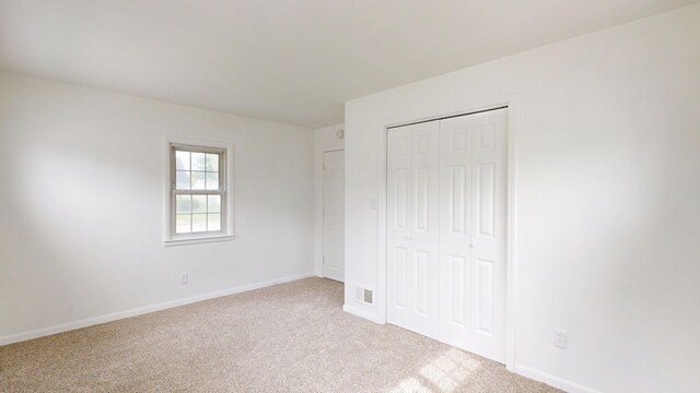 6 Congress Ct Unit D, Saginaw, MI 48602 - unfurnished bedroom featuring carpet flooring, a closet, and baseboards
