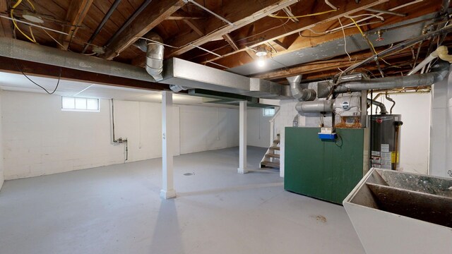 6 Congress Ct Unit D, Saginaw, MI 48602 - basement with gas water heater, a sink, stairway, and heating unit