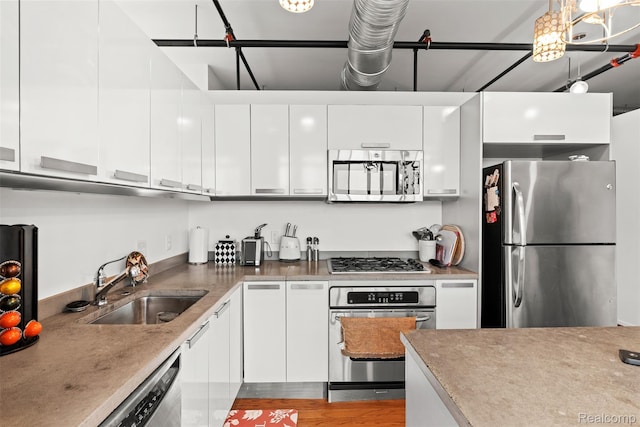 100 N Center St Unit 404, Royal Oak, MI 48067 - kitchen with appliances with stainless steel finishes, white cabinetry, and light countertops