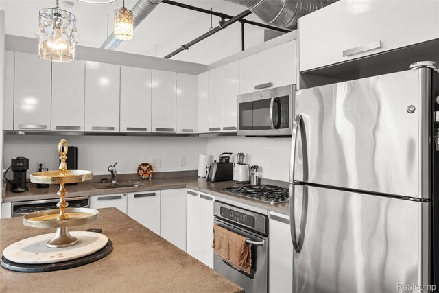 100 N Center St Unit 404, Royal Oak, MI 48067 - kitchen with appliances with stainless steel finishes, modern cabinets, white cabinetry, and pendant lighting