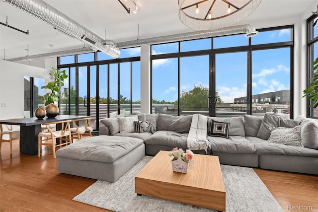 100 N Center St Unit 404, Royal Oak, MI 48067 - living room featuring wood finished floors, a wall of windows, and a high ceiling