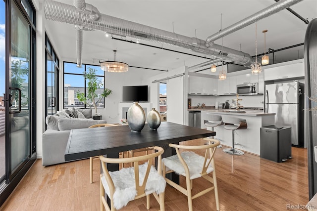 100 N Center St Unit 404, Royal Oak, MI 48067 - dining room with light wood-style flooring and expansive windows