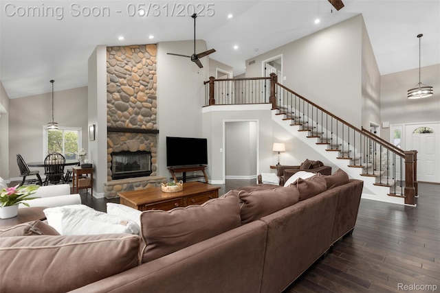 4470 Coastal Pkwy, White Lake, MI 48386 - living area featuring high vaulted ceiling, stairs, dark wood-style flooring, a stone fireplace, and baseboards