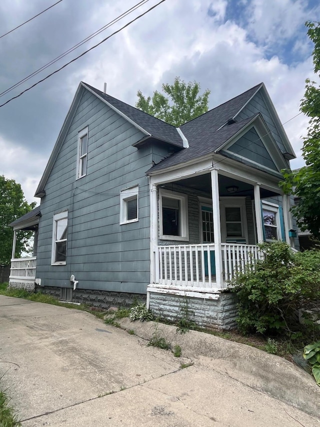611 New Ave SW, Grand Rapids, MI 49503 - view of side of home featuring a porch and a shingled roof