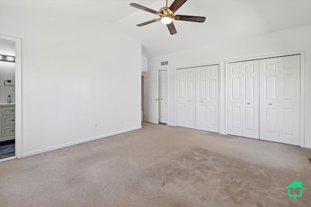 7458 Knollwood Dr, Ypsilanti, MI 48197 - unfurnished bedroom with vaulted ceiling, carpet flooring, two closets, baseboards, and ensuite bathroom