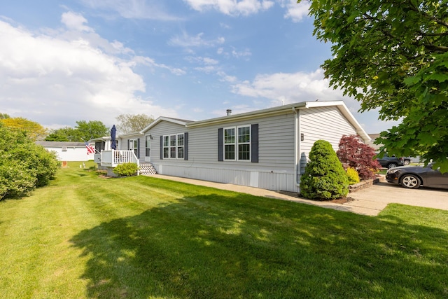 305 Oak Ridge St, Mason, MI 48854 - rear view of property with a yard
