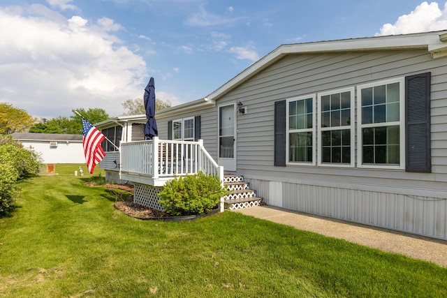 305 Oak Ridge St, Mason, MI 48854 - back of property with a wooden deck and a lawn