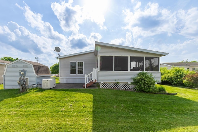 305 Oak Ridge St, Mason, MI 48854 - back of house with a sunroom and a yard