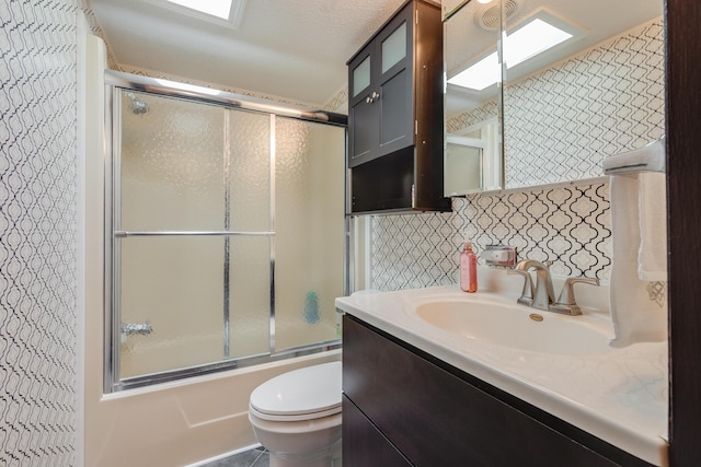 305 Oak Ridge St, Mason, MI 48854 - bathroom with combined bath / shower with glass door, toilet, and vanity