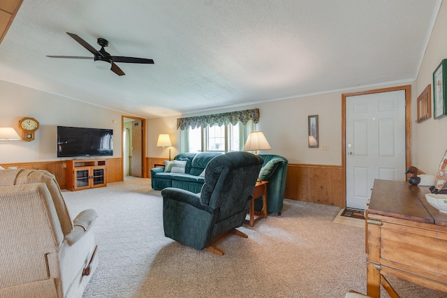305 Oak Ridge St, Mason, MI 48854 - carpeted living room featuring wainscoting, wood walls, a textured ceiling, and ceiling fan