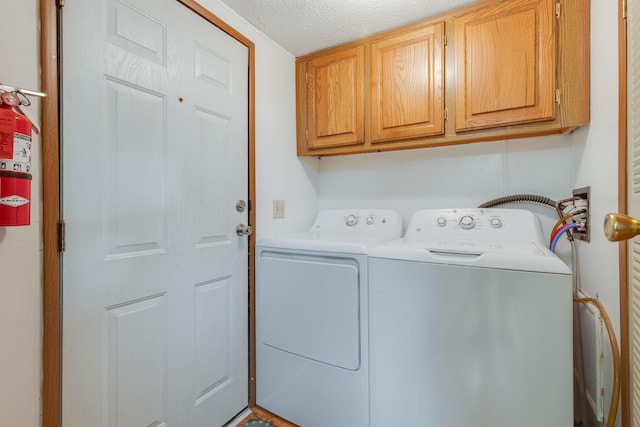 305 Oak Ridge St, Mason, MI 48854 - washroom featuring cabinet space, washing machine and dryer, and a textured ceiling