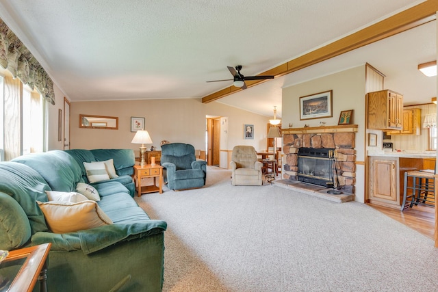 305 Oak Ridge St, Mason, MI 48854 - living area with a ceiling fan, a fireplace, light colored carpet, and a textured ceiling