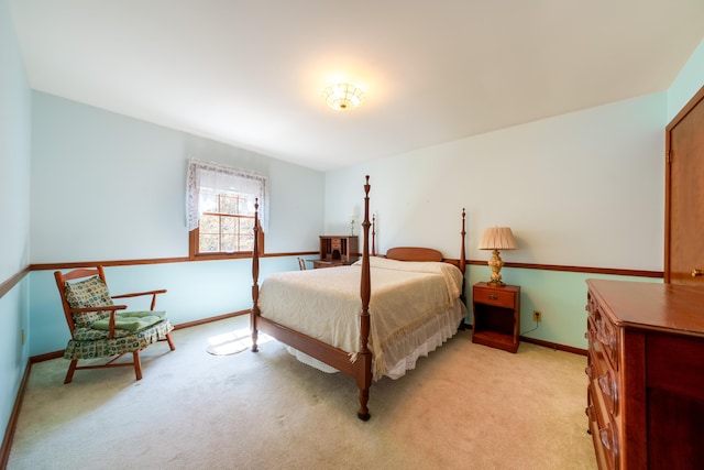 bedroom featuring light carpet and baseboards