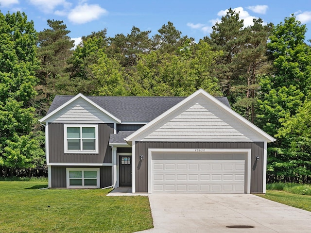 20630 Rolling Hills Ln, Big Rapids, MI 49307 - view of front of home with driveway, a front yard, a shingled roof, and an attached garage