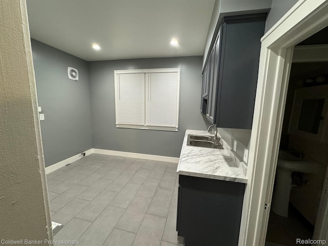 2474 Atkinson St, Detroit, MI 48206 - kitchen with a sink, light countertops, recessed lighting, and baseboards