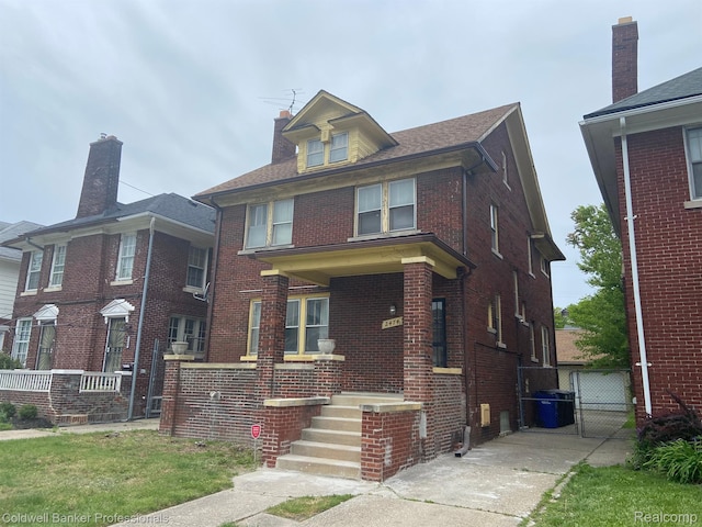 2474 Atkinson St, Detroit, MI 48206 - american foursquare style home with brick siding, a gate, and a chimney
